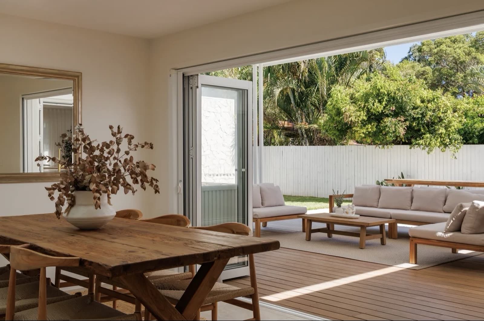 Timber deck and outdoor lounge area connected to an indoor dining room