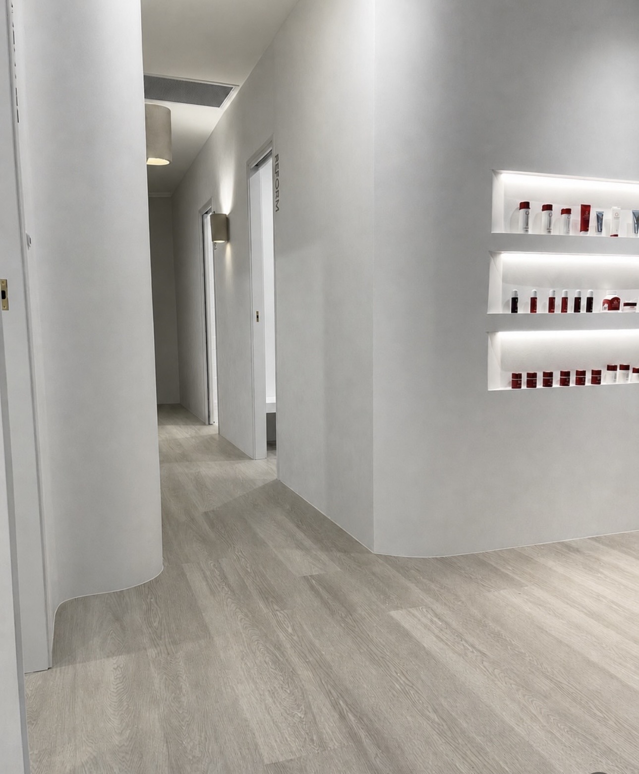 Pale grey oak-look hybrid flooring through a Gold Coast salon fit-out
