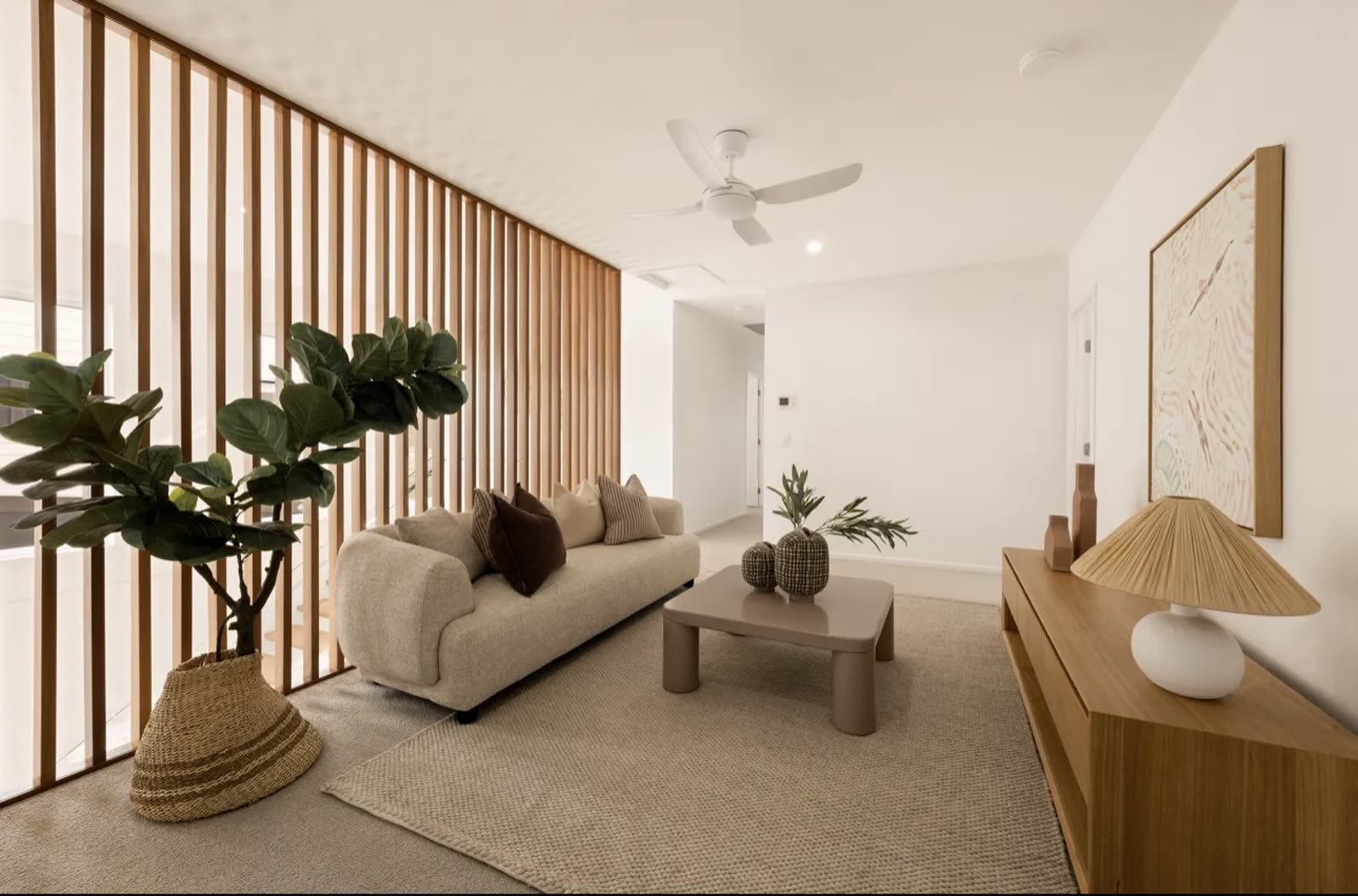 Lounge room with timber slat room divider and soft neutral styling
