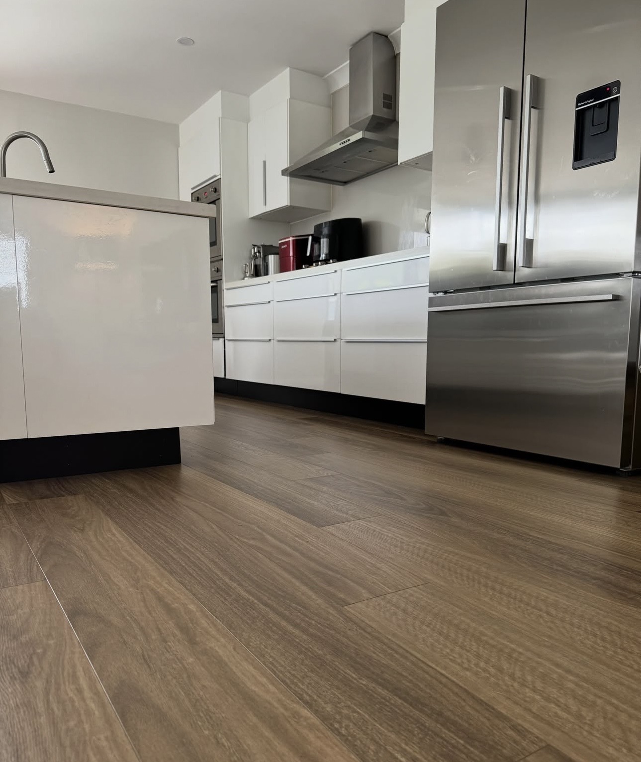 Rich brown timber-look hybrid flooring in a Gold Coast kitchen
