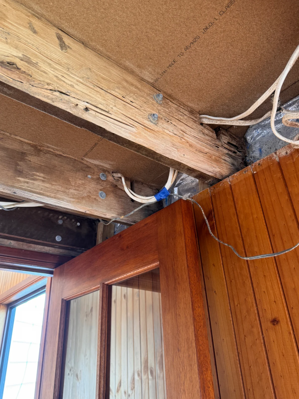 Close-up of termite damage in exposed timber beams
