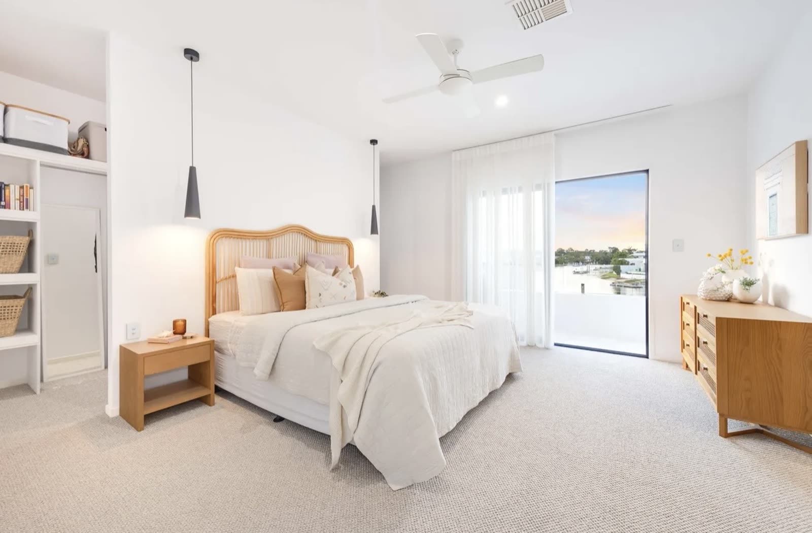 Renovated bedroom with built-in shelving and sliding door to a balcony