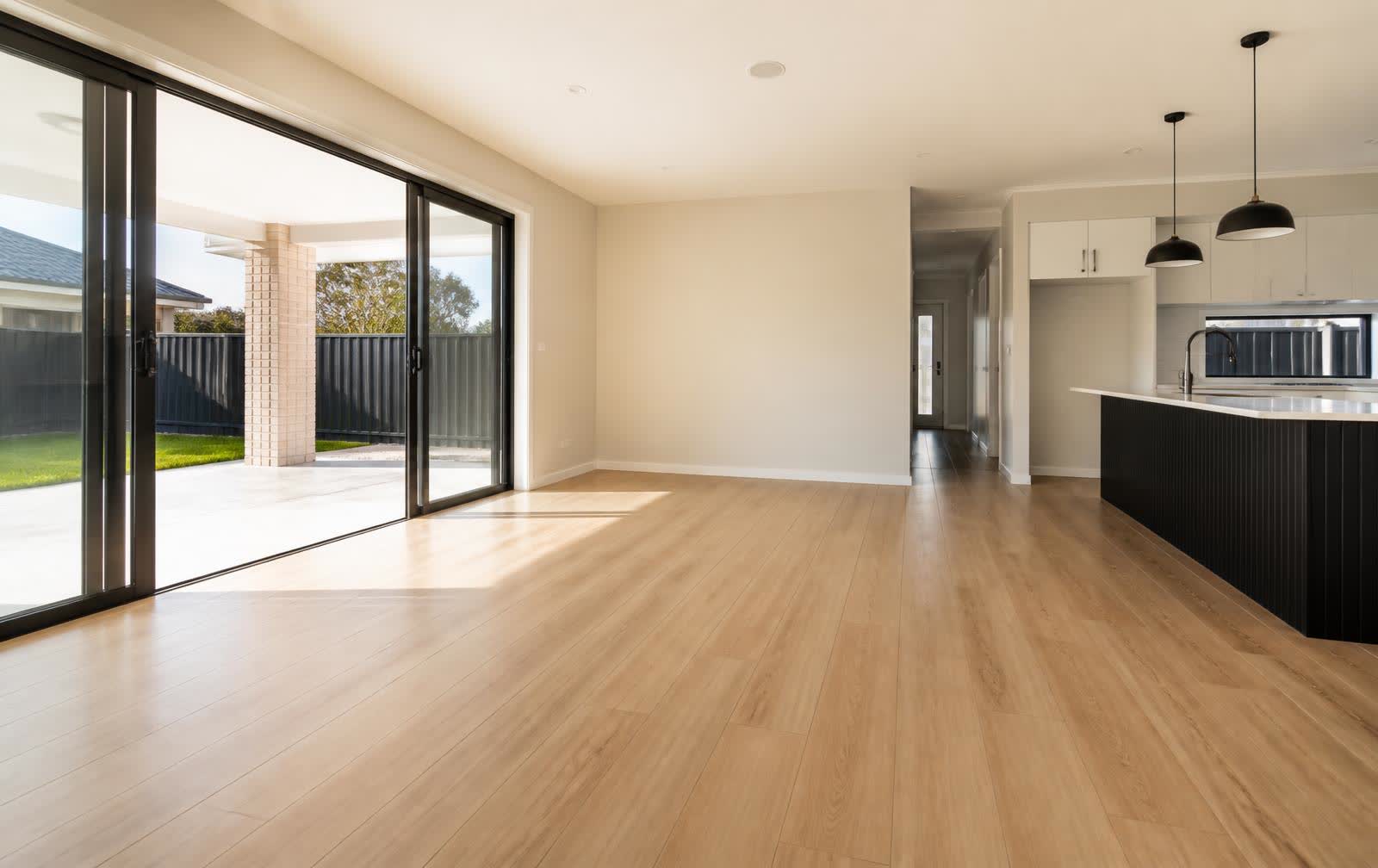 Newly installed hybrid timber-look flooring in an open-plan living area