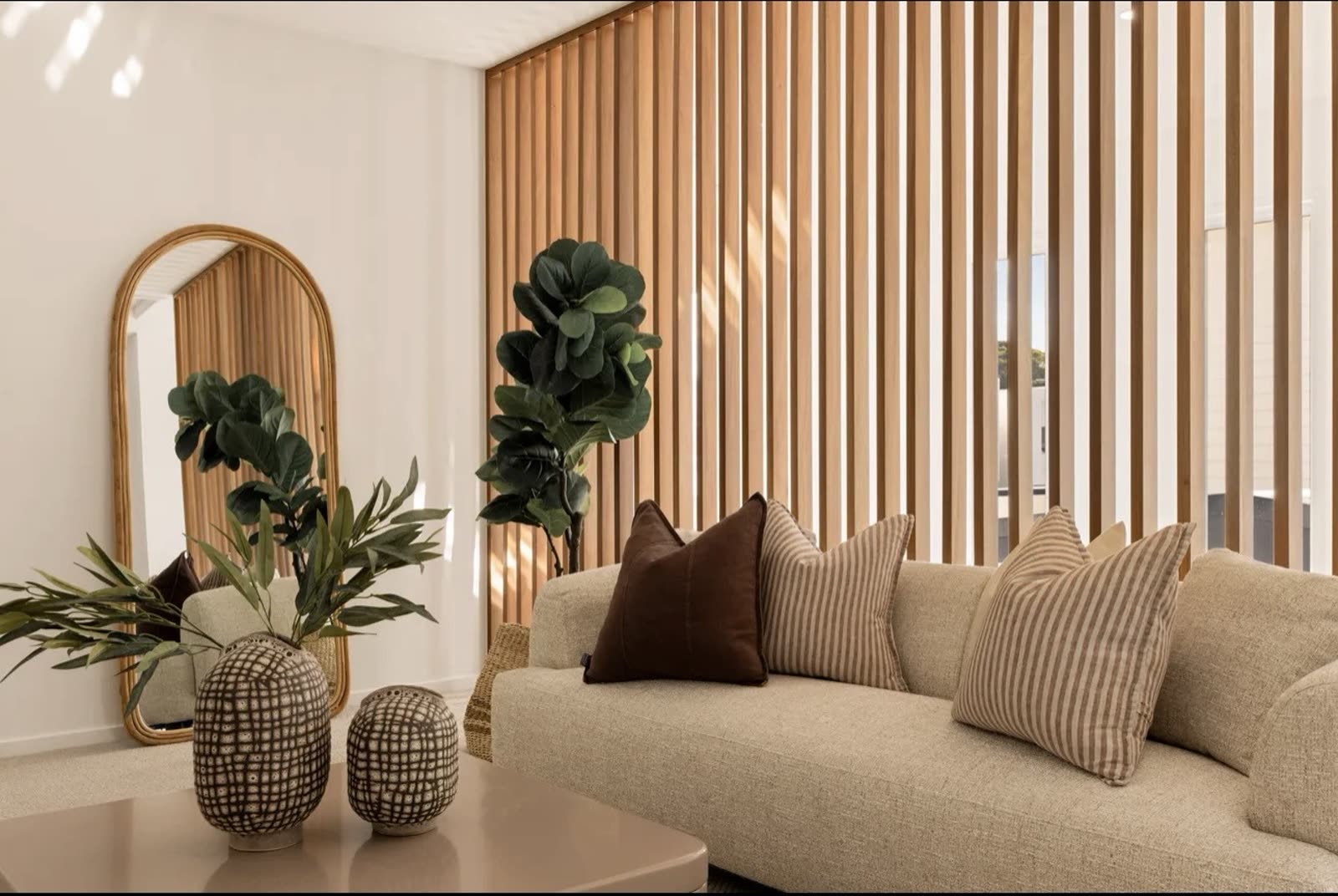 Living room with custom timber batten feature wall built by Orange Projects