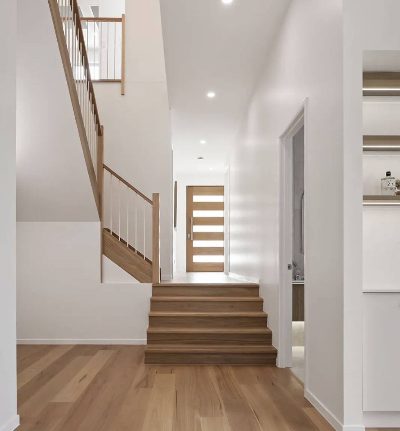 Timber flooring and matching stair treads in a Gold Coast entry hall
