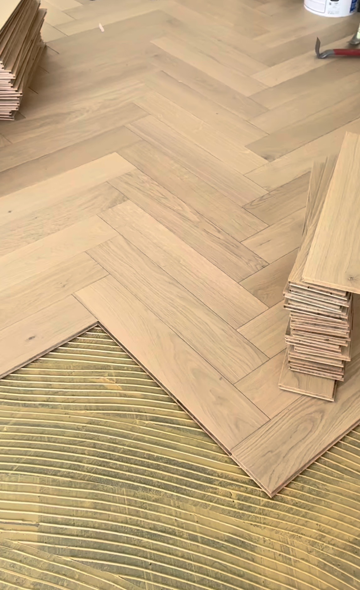 Oak herringbone flooring being laid over trowelled adhesive, Gold Coast