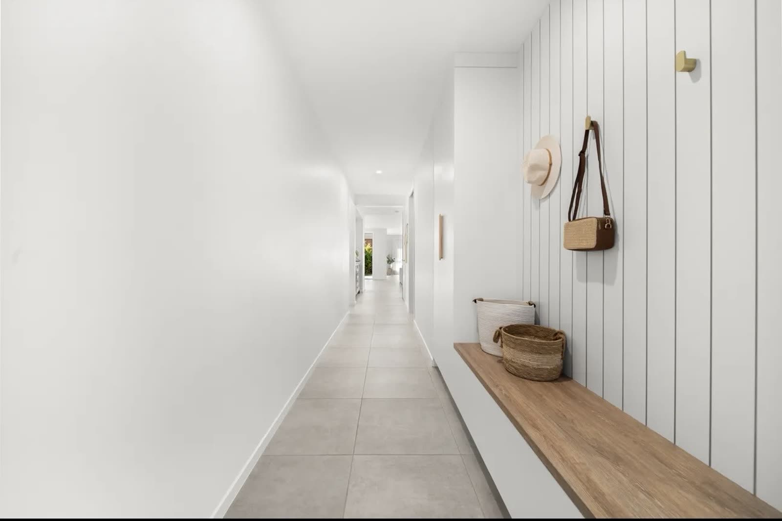 Entry hallway with vertical panelling and custom floating timber bench seat