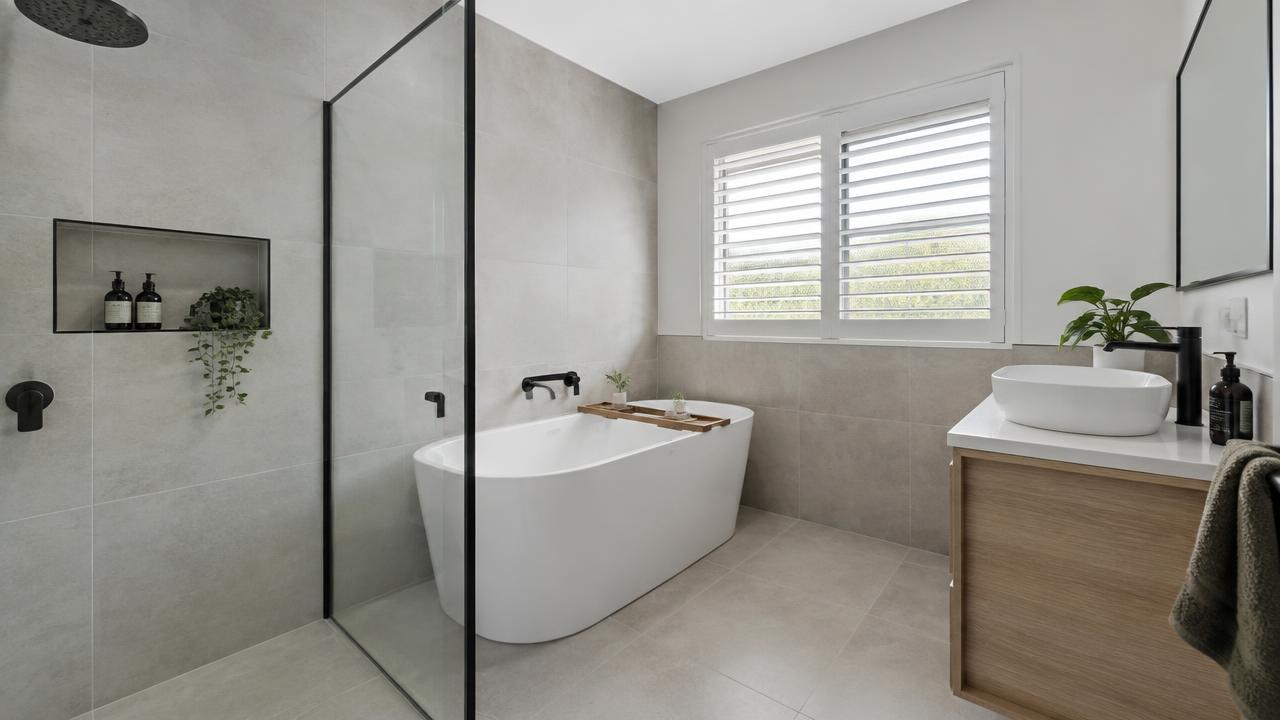Renovated bathroom in a Logan home with new tiling and vanity
