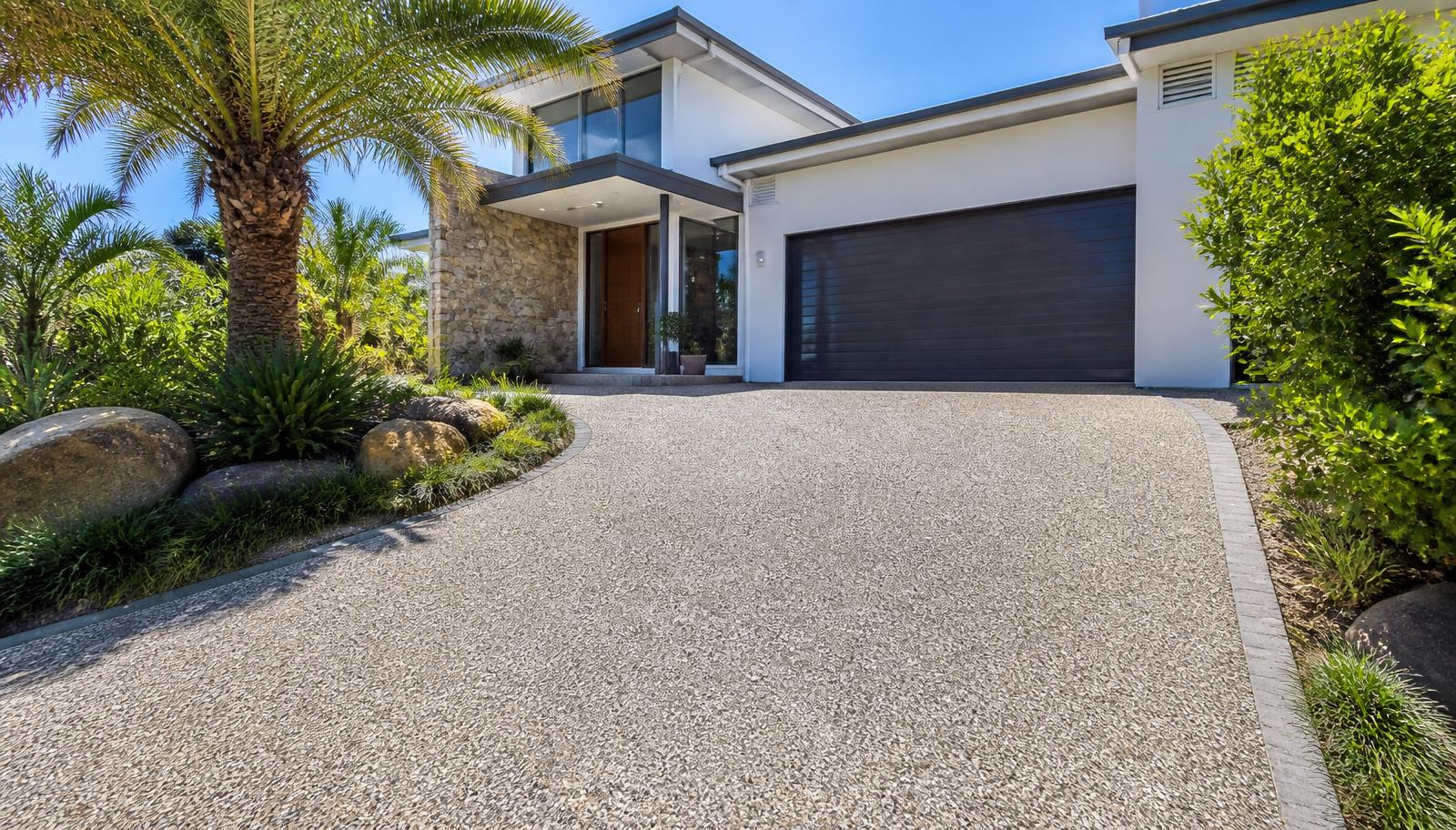Exposed aggregate concrete driveway with visible stone finish