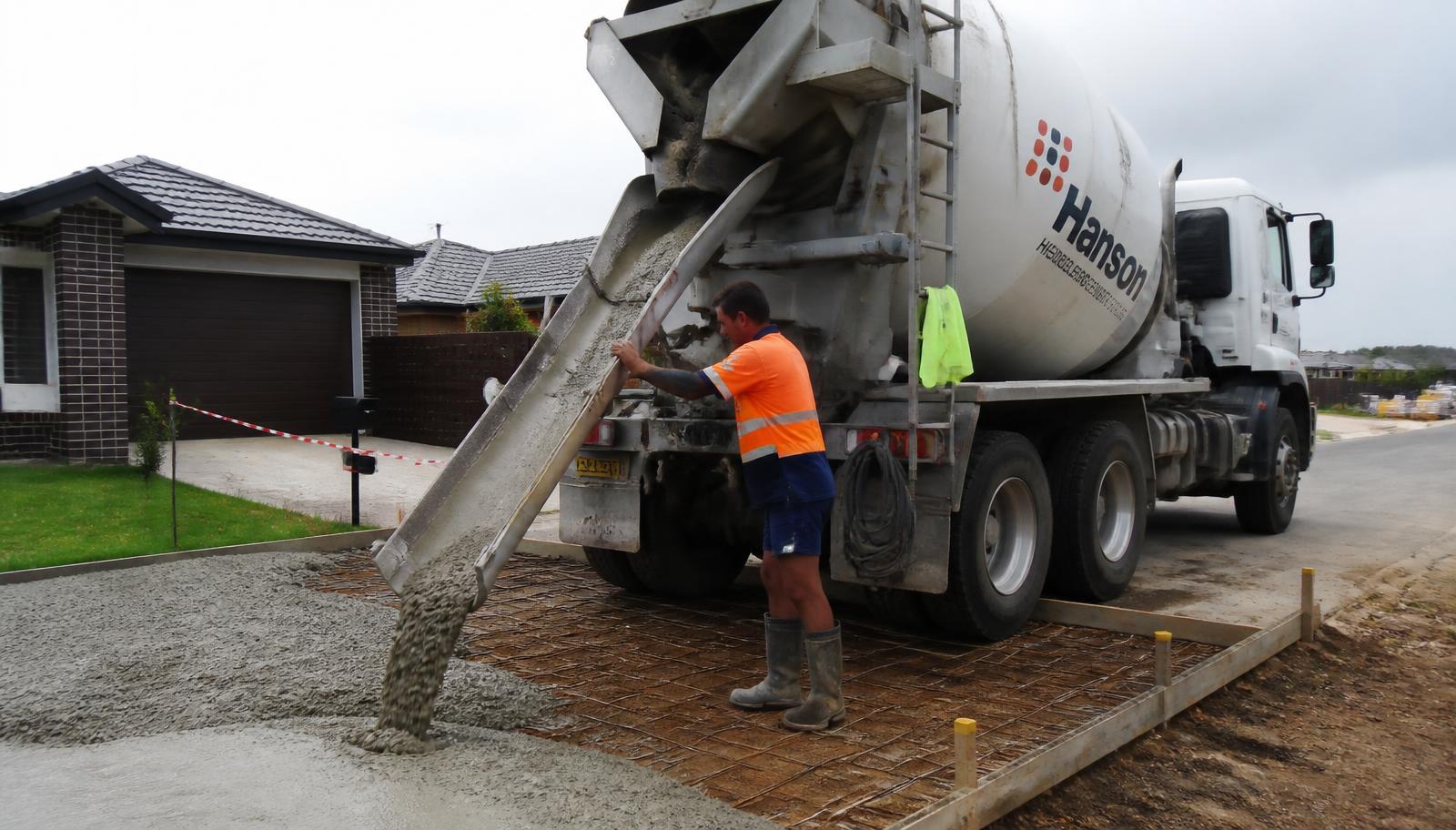 Concrete being placed and screeded on a residential slab