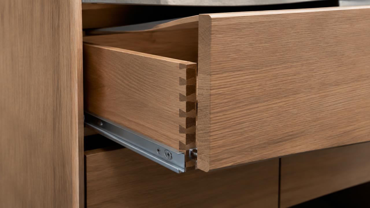 Cabinetmaker fitting custom kitchen cabinetry in a Gold Coast home